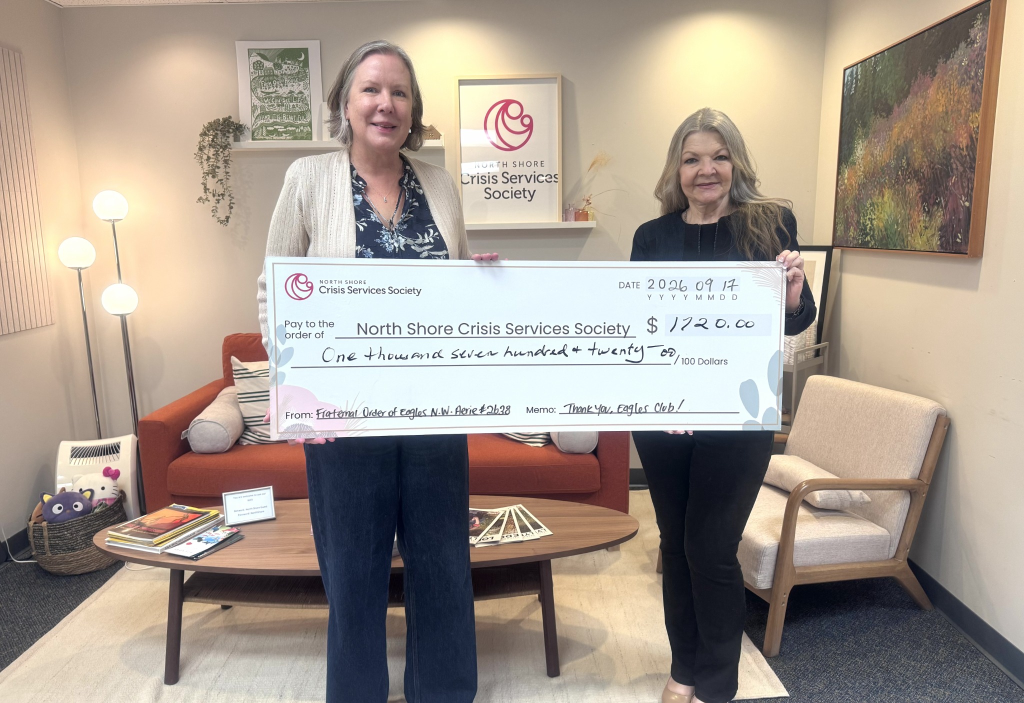 Judith Cahill presenting a cheque to Laura at North Shore Crisis Services Society