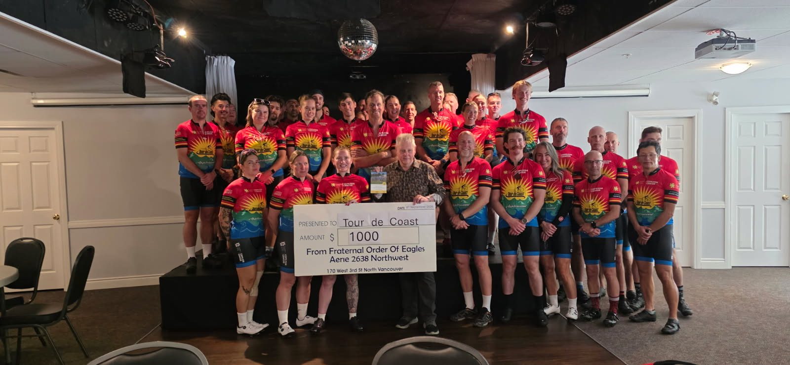 Tour de Coast riders receiving a one thousand dollar donation from the Eagles Club North Vancouver